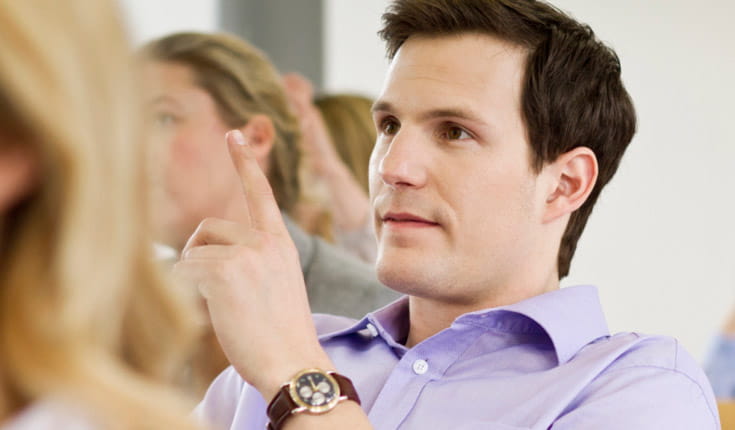 Man in purple shirt asking question