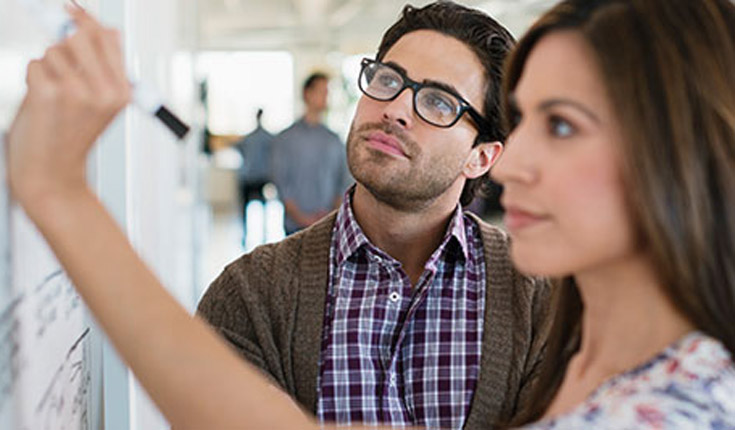 man and woman at whiteboard
