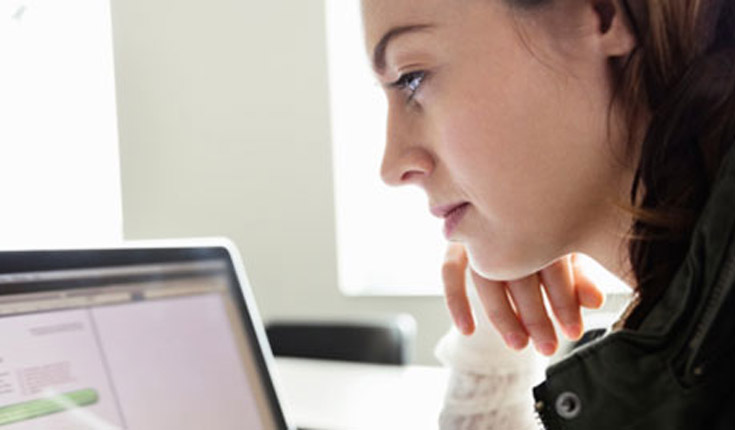Woman Staring at Laptop