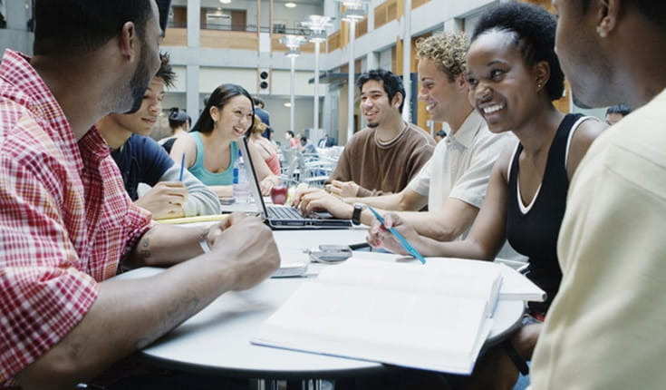 Students Sat Around a Desk
