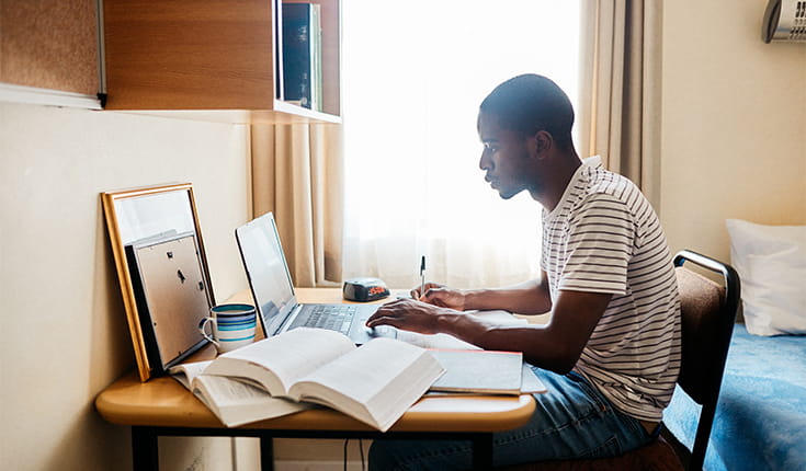 Man Studies by Window