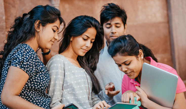 students sharing tablet