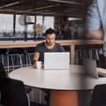 man with laptop in coffeeshop