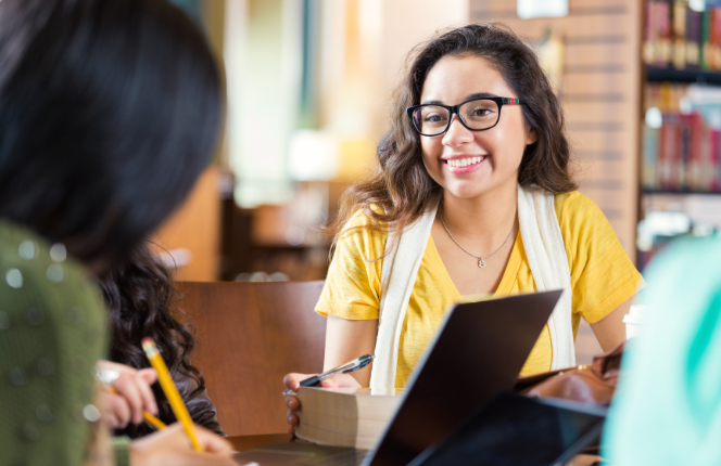 Young woman studying with others